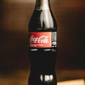 Close-up of a chilled Coca-Cola glass bottle, perfect for refreshing moments.